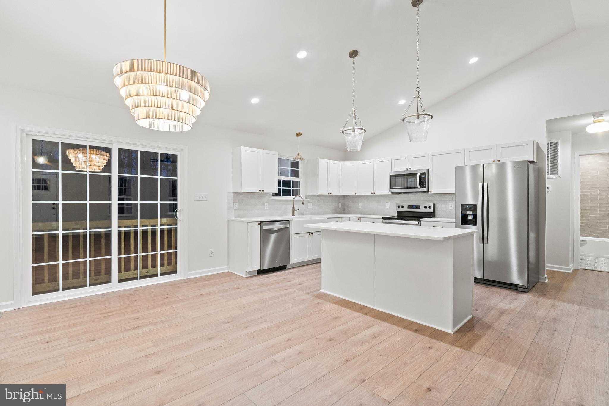 1080 Eastham Road Bumpass, VA 23024 - Photo 9 of 43 a large kitchen with kitchen island a sink stainless steel appliances and cabinets