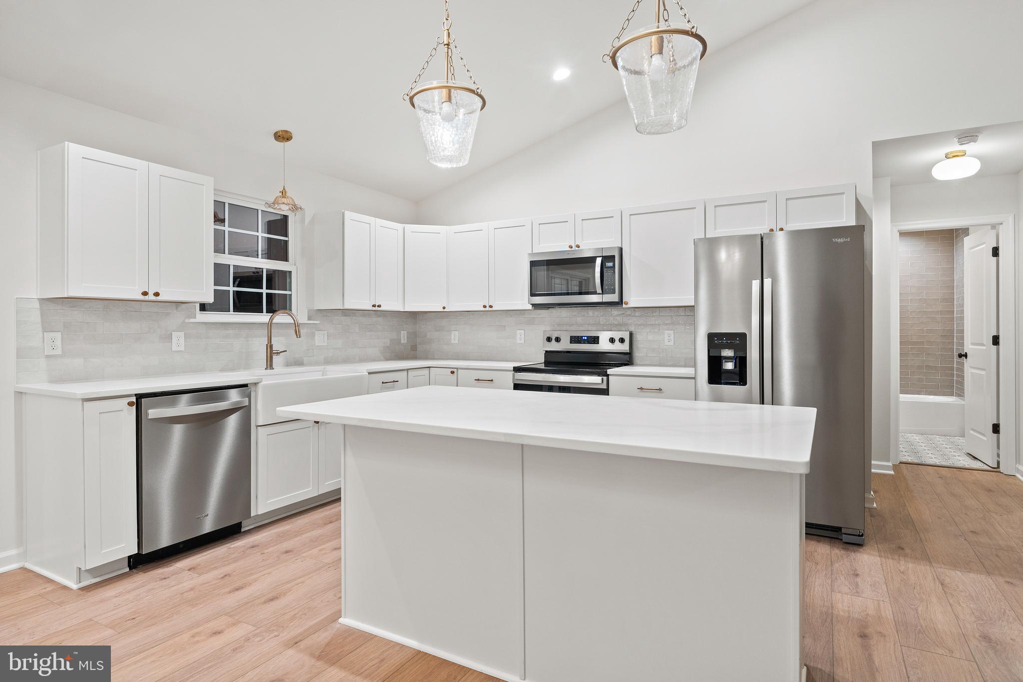 1080 Eastham Road Bumpass, VA 23024 - Photo 10 of 43 a kitchen with kitchen island granite countertop stainless steel appliances cabinets a sink and a counter space