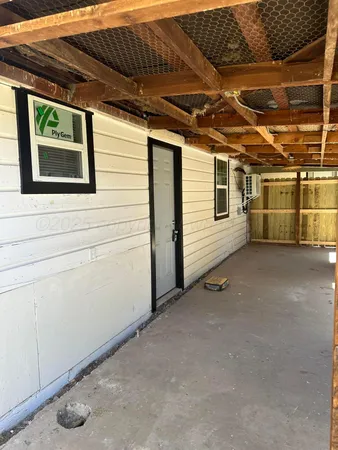 a view of a water heater and a car in a parking space
