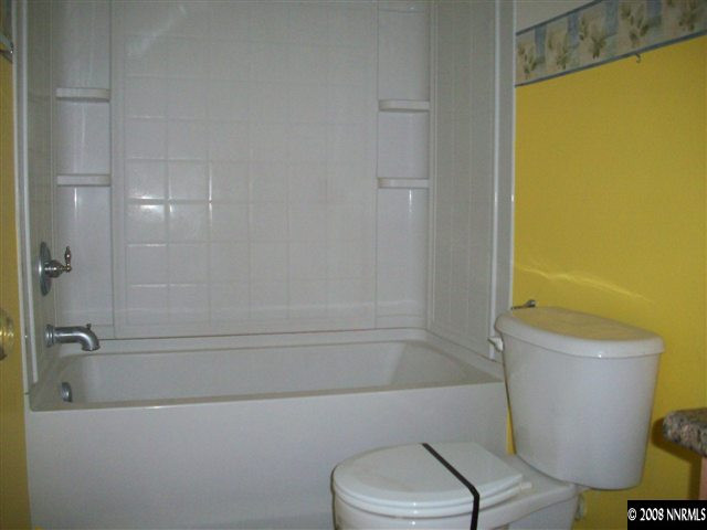 9275 Red Baron Boulevard Reno, NV 89506 - Photo 4 of 9 a bathroom with a toilet and a bathtub