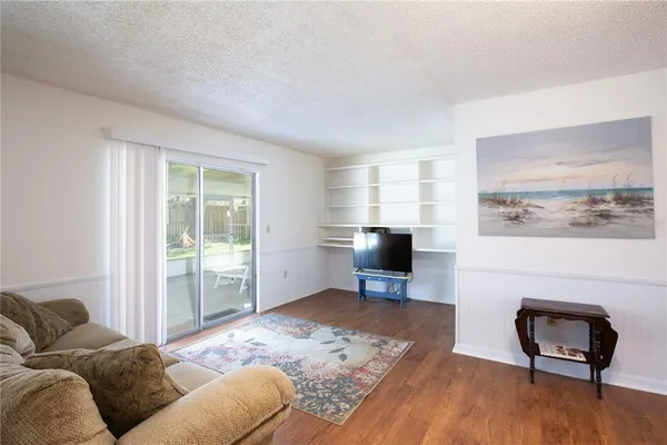 a bedroom with furniture and a wooden floor