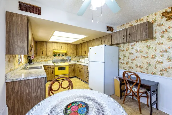 a kitchen with stainless steel appliances granite countertop wooden cabinets and a sink