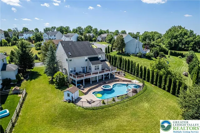 a kitchen with stainless steel appliances granite countertop a refrigerator a stove a sink dishwasher and a dining table with wooden floor