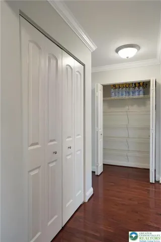 a kitchen with stainless steel appliances kitchen island granite countertop wooden cabinets and wooden floor