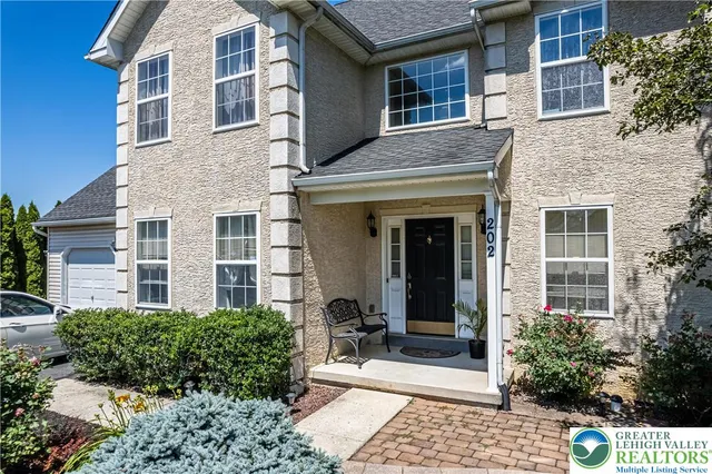 front view of a brick house with a small yard