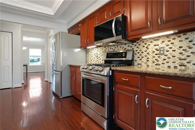 a living room with furniture a fireplace and a large window