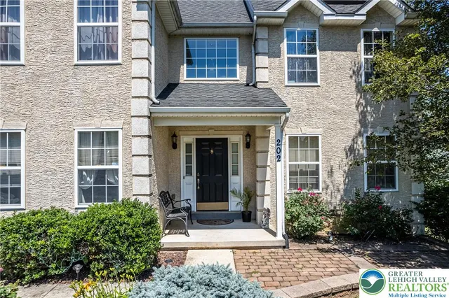 a view of a house with swimming pool and sitting area