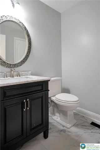 a bathroom with a sink mirror and toilet