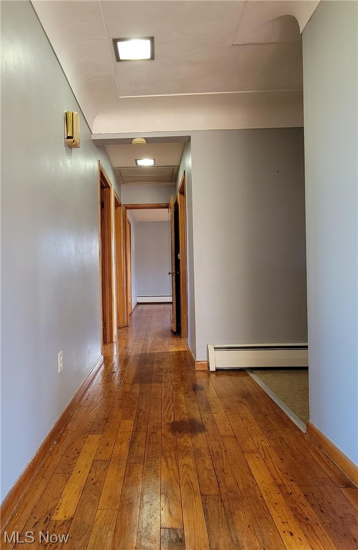 405 Bryan Road Milan, OH 44846 - Photo 12 of 35 Hall with hardwood / wood flooring and a baseboard heating unit
