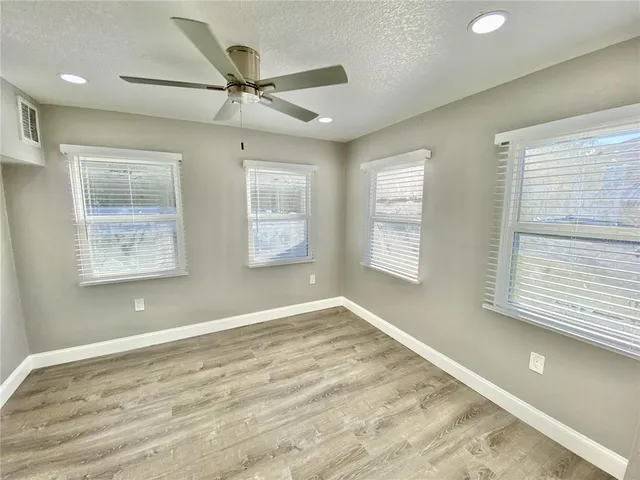 a view of a livingroom with a ceiling fan and window