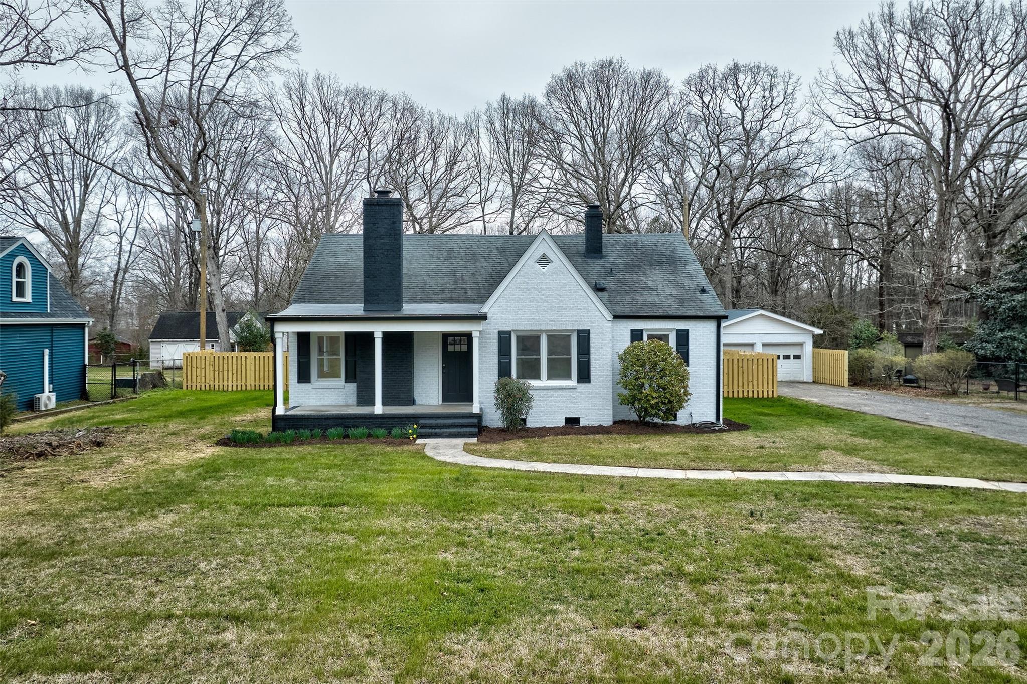 a front view of a house with a garden