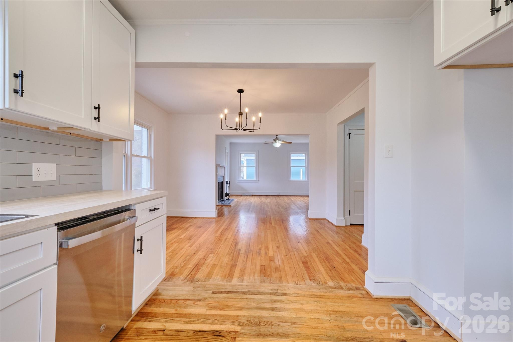 804 Congress Street North York, SC 29745 - Photo 12 of 48 a view of a kitchen with kitchen island a sink wooden floor and a living room view