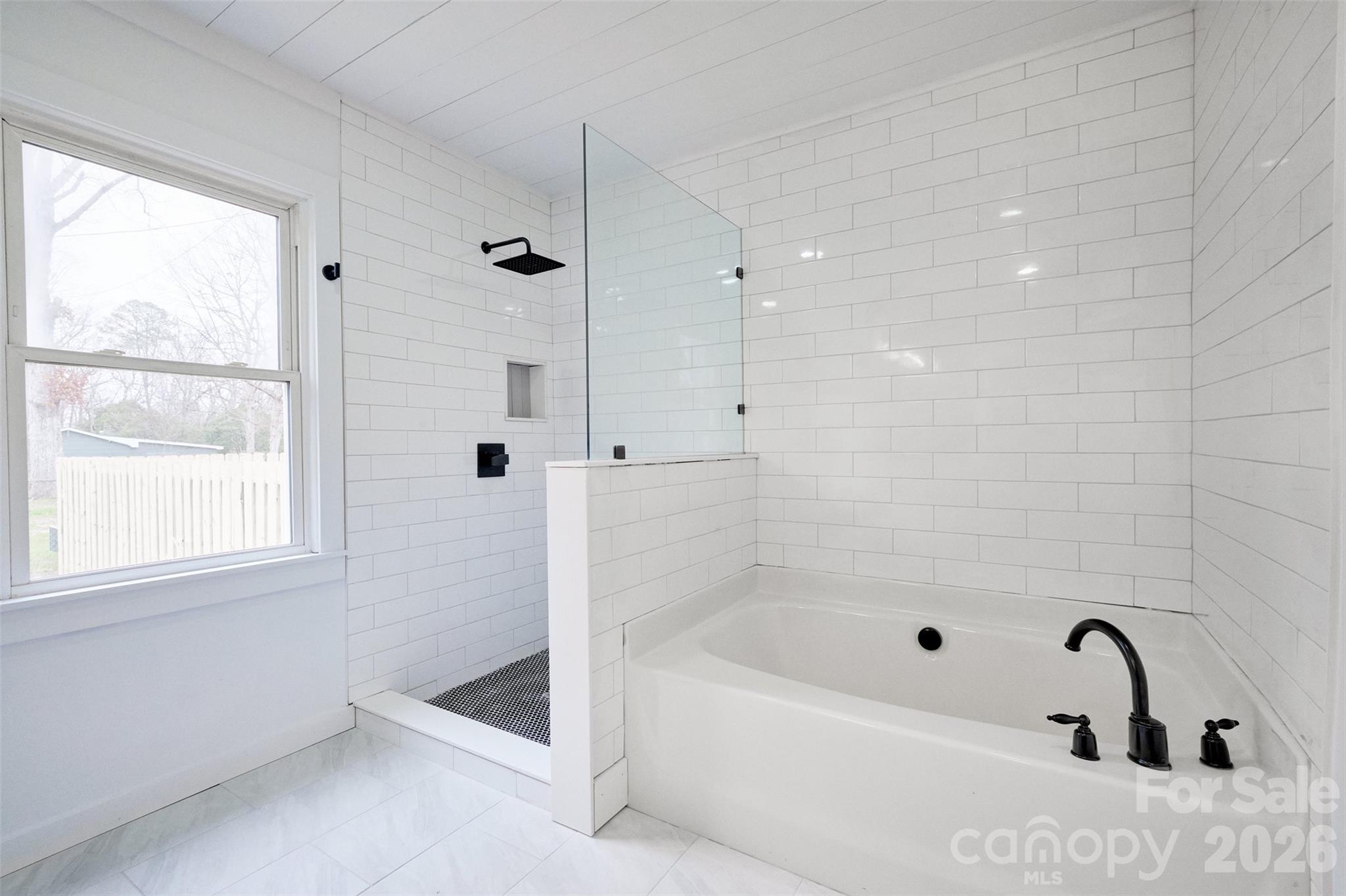 804 Congress Street North York, SC 29745 - Photo 22 of 48 a bathroom with a tub a window and a shower