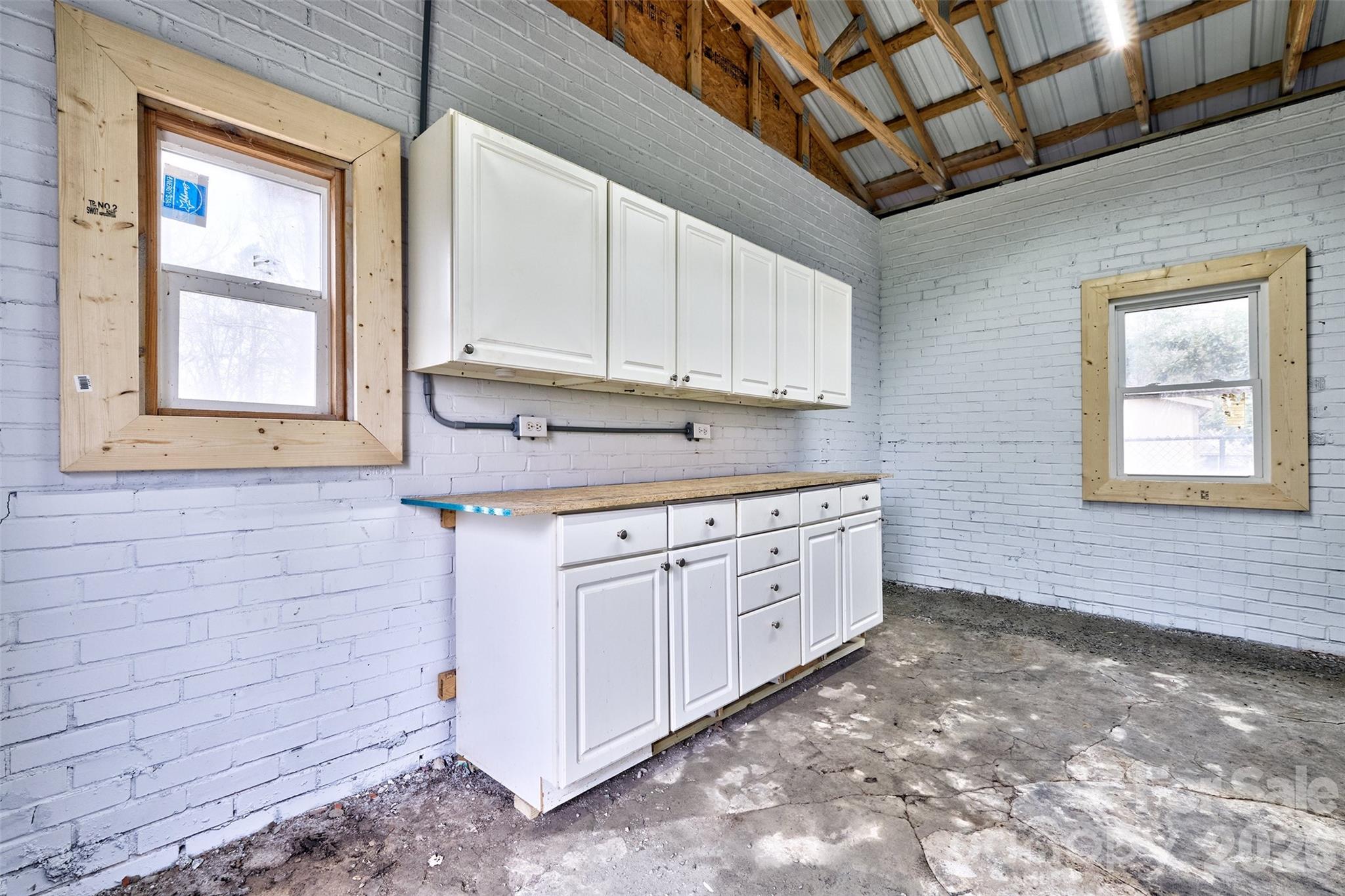 804 Congress Street North York, SC 29745 - Photo 39 of 48 a kitchen with granite countertop white cabinets stainless steel appliances a sink and a window