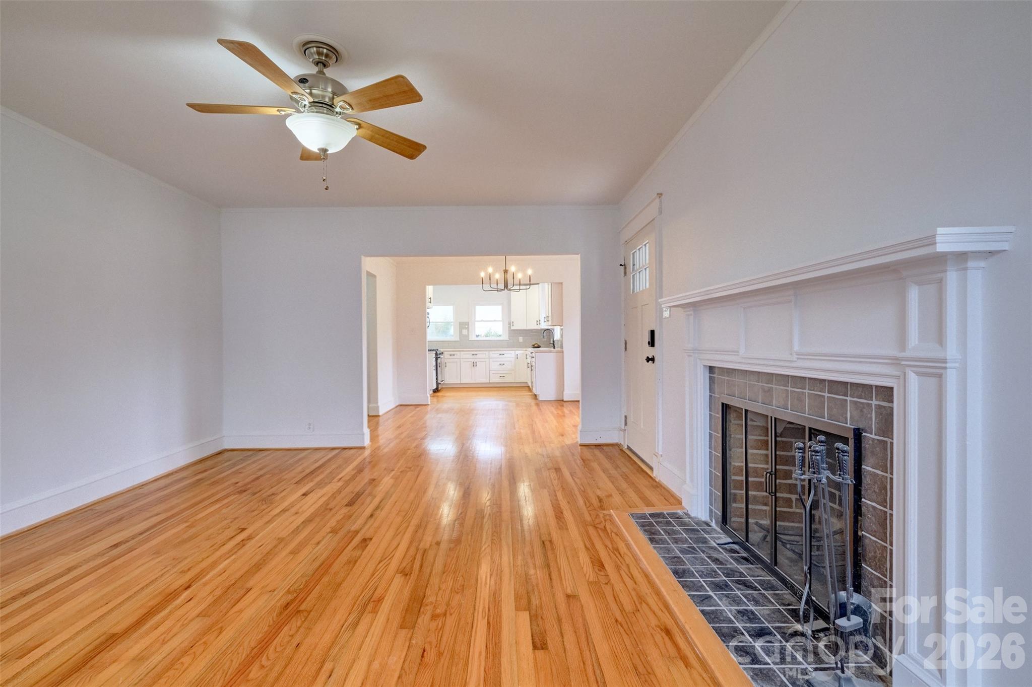 804 Congress Street North York, SC 29745 - Photo 5 of 48 an empty room with wooden floor fireplace and windows