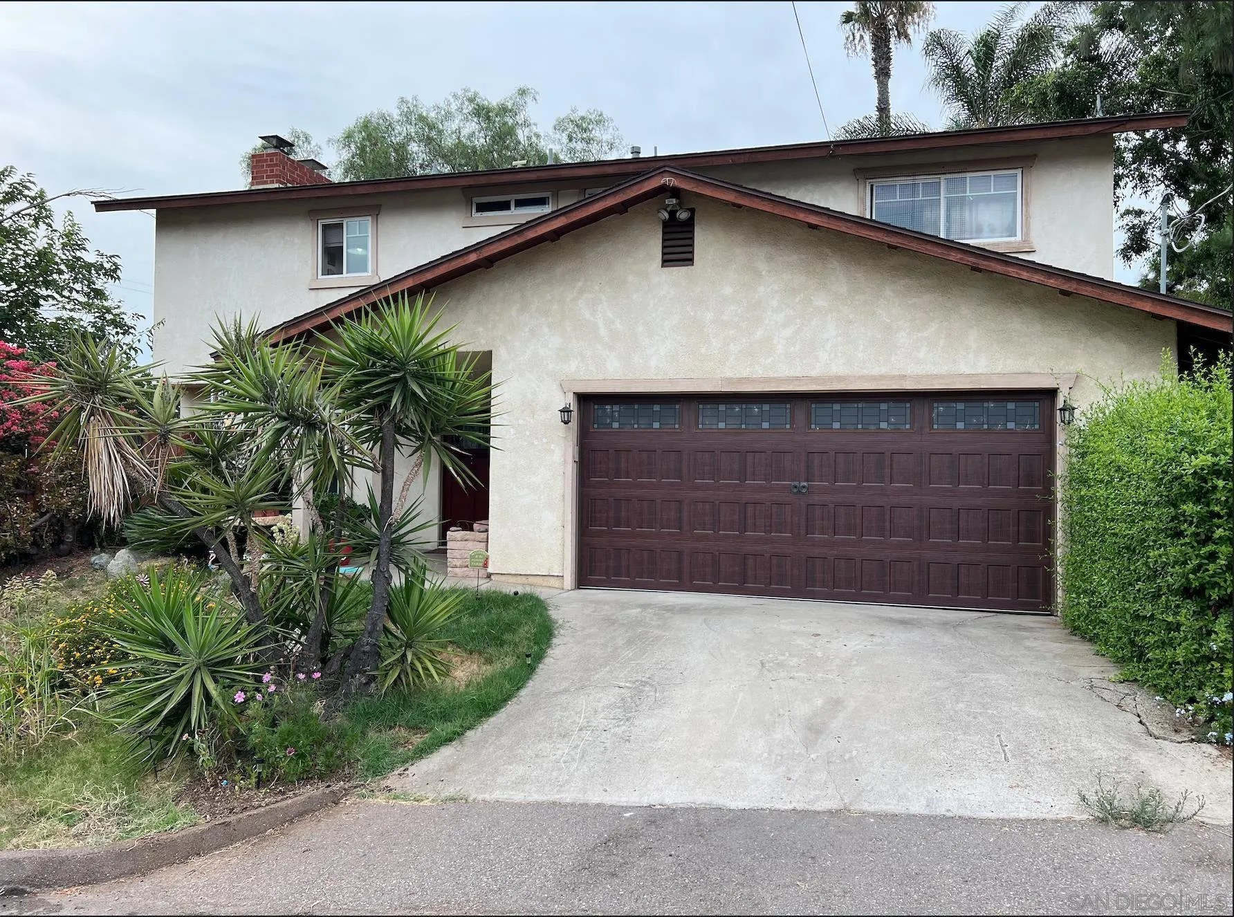 9306 Hollyhock Lane Spring Valley, CA 91977 - Photo 1 of 6 a front view of house with garage