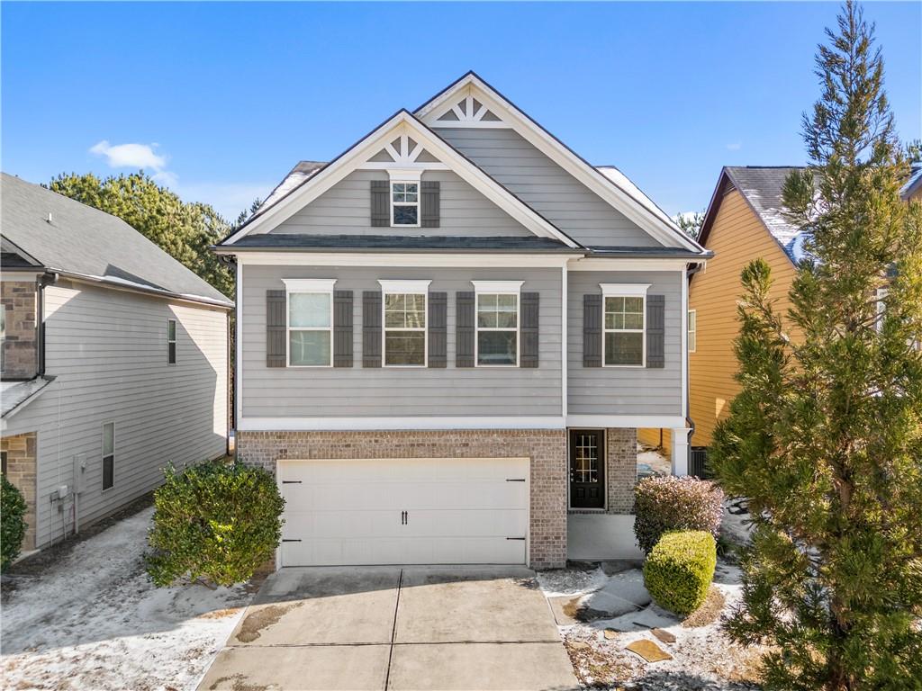 a front view of a house with plants