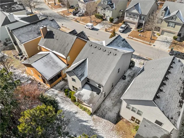 an aerial view of a house with a yard