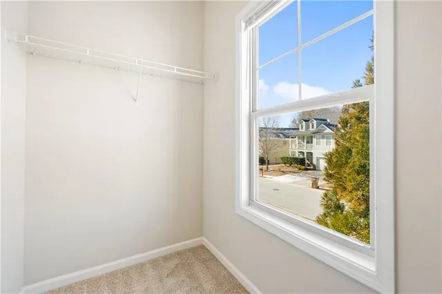 a view of a small space with wooden floor and a window