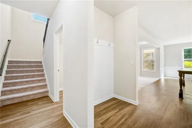 a view of a room with wooden floor and stairs