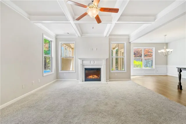 a view of an empty room with a fireplace and a window
