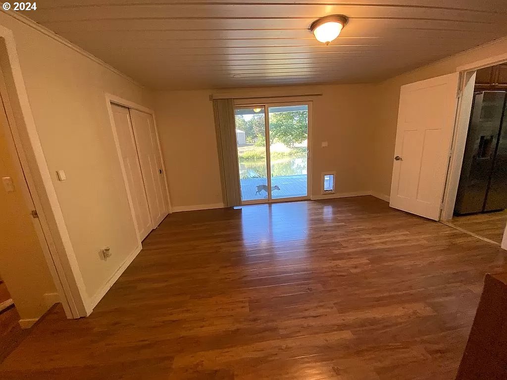 34036 Row River Road Cottage Grove, OR 97424 - Photo 10 of 15 a view of an empty room with wooden floor and a window