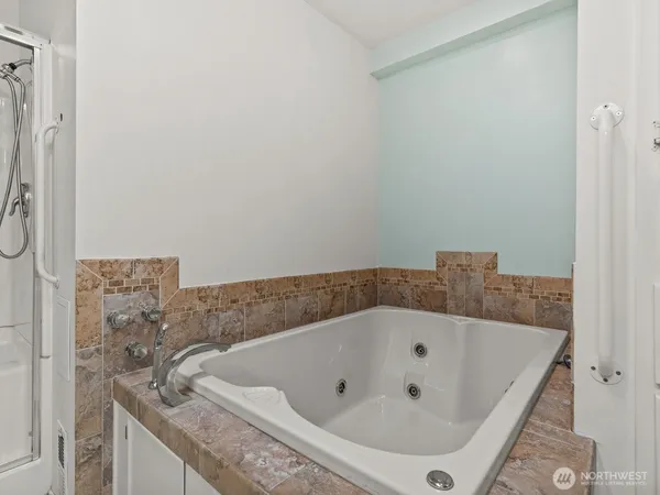 a bathroom with a shower and a glass door