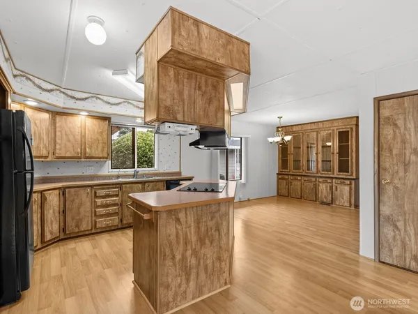a kitchen with stainless steel appliances granite countertop a sink a stove and a refrigerator