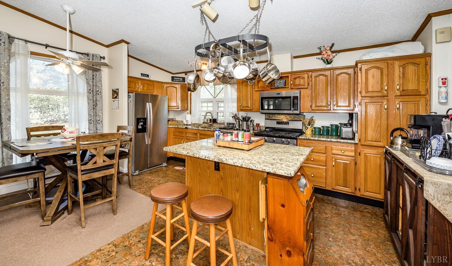 461 Byrd Mill Road Louisa, VA 23093 - Photo 21 of 81 a kitchen with granite countertop lots of counter top space and stainless steel appliances