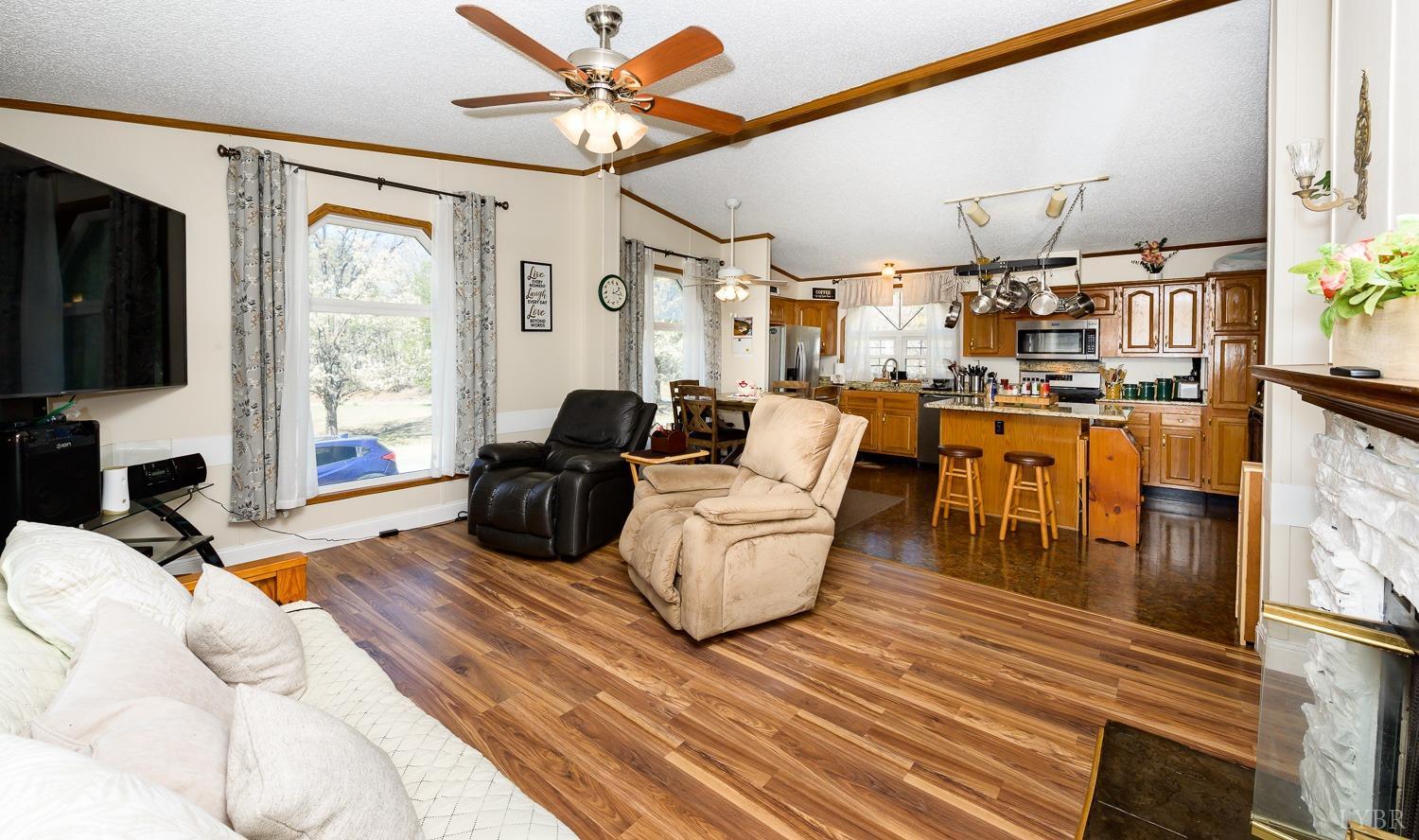 461 Byrd Mill Road Louisa, VA 23093 - Photo 26 of 81 a living room with furniture a flat screen tv and a fireplace