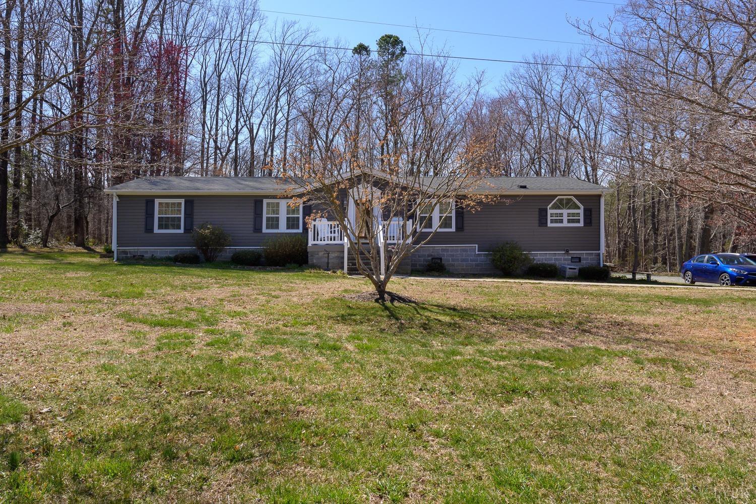461 Byrd Mill Road Louisa, VA 23093 - Photo 55 of 81 a front view of a house with a yard and garage