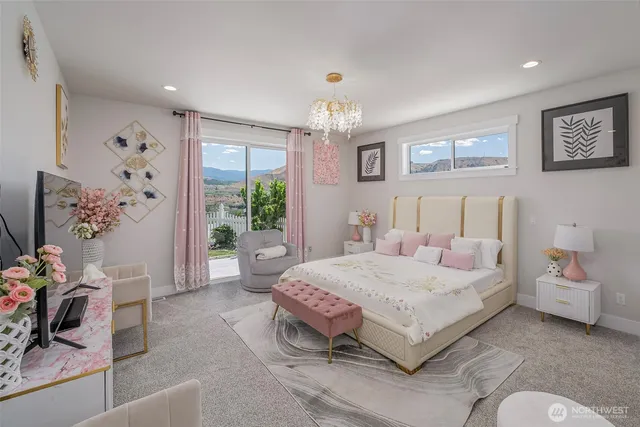 a spacious bedroom with a bed and a chandelier