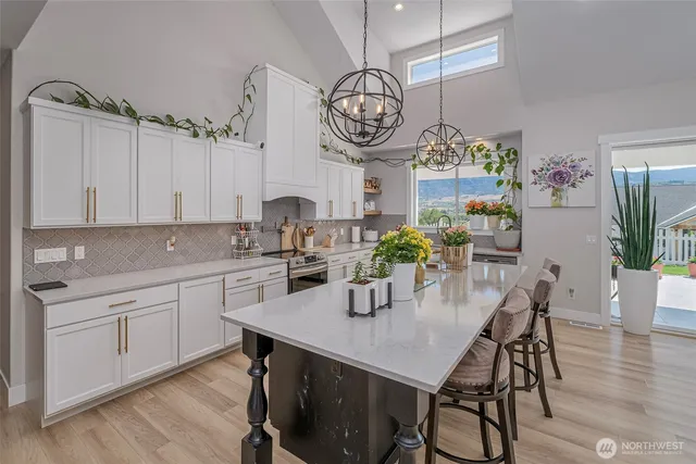 a view of kitchen with cabinets table and chairs