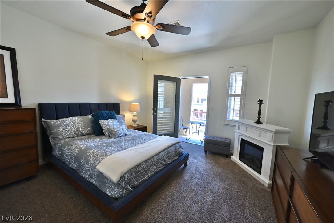 2729 Kildrummie Street Henderson, NV 89044 - Photo 23 of 42 A well-appointed bedroom features a private balcony and an inviting fireplace.