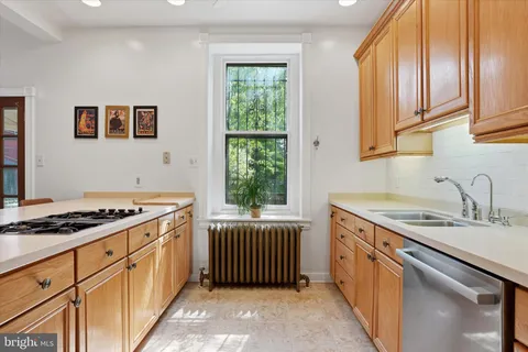 a kitchen with stainless steel appliances granite countertop a sink stove and cabinets