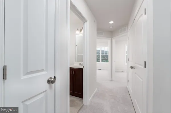 a view of a hallway with wooden shelves