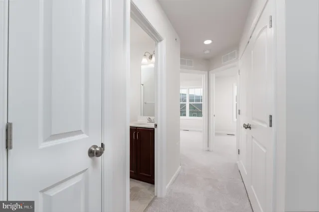 a view of a hallway with wooden shelves