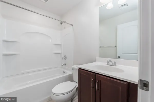 a bathroom with a sink a toilet and a bathtub