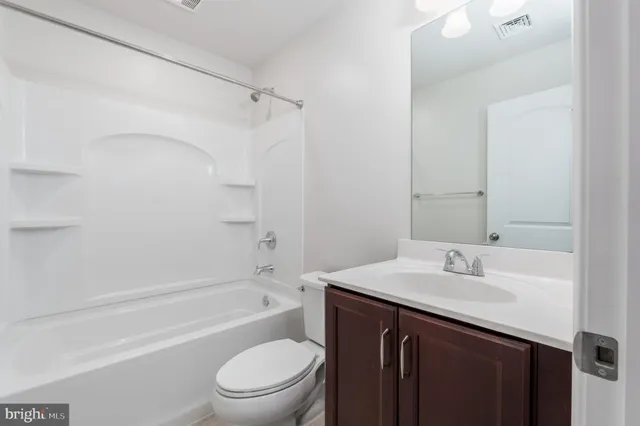 a bathroom with a sink a toilet and a bathtub