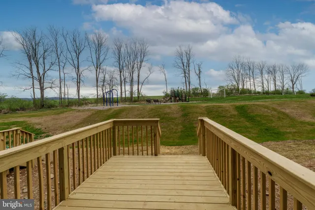 a view of a lake with a wooden bridge
