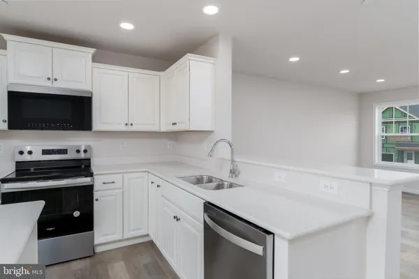 a kitchen with a sink stove and cabinets