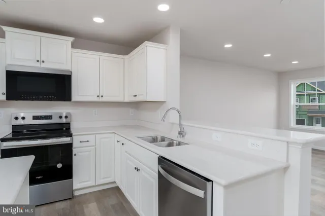 a kitchen with a sink stove and cabinets