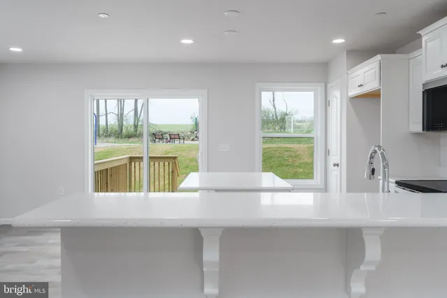a kitchen with a sink and a large window