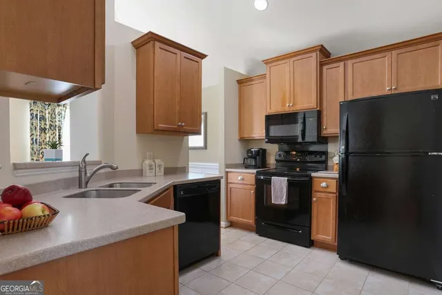 a kitchen with a sink a stove and refrigerator