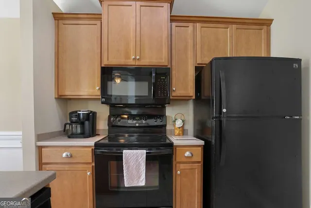 a kitchen with a refrigerator stove and cabinets