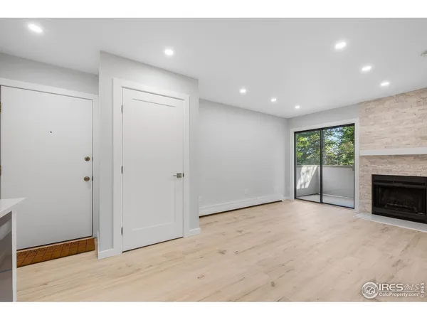 a view of an empty room with a fireplace