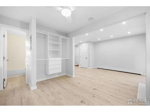 a view of an empty room with wooden floor