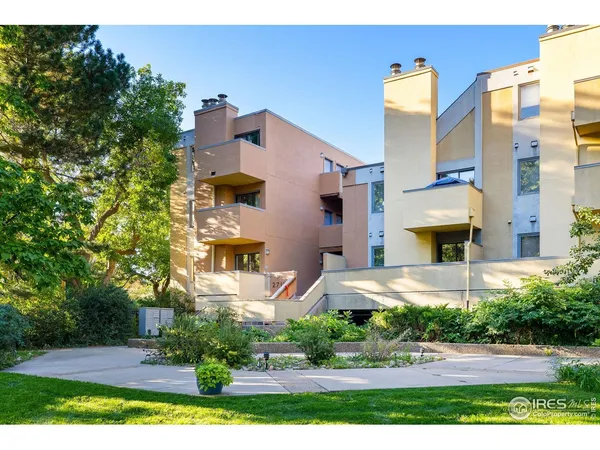 a front view of a residential apartment building with a yard