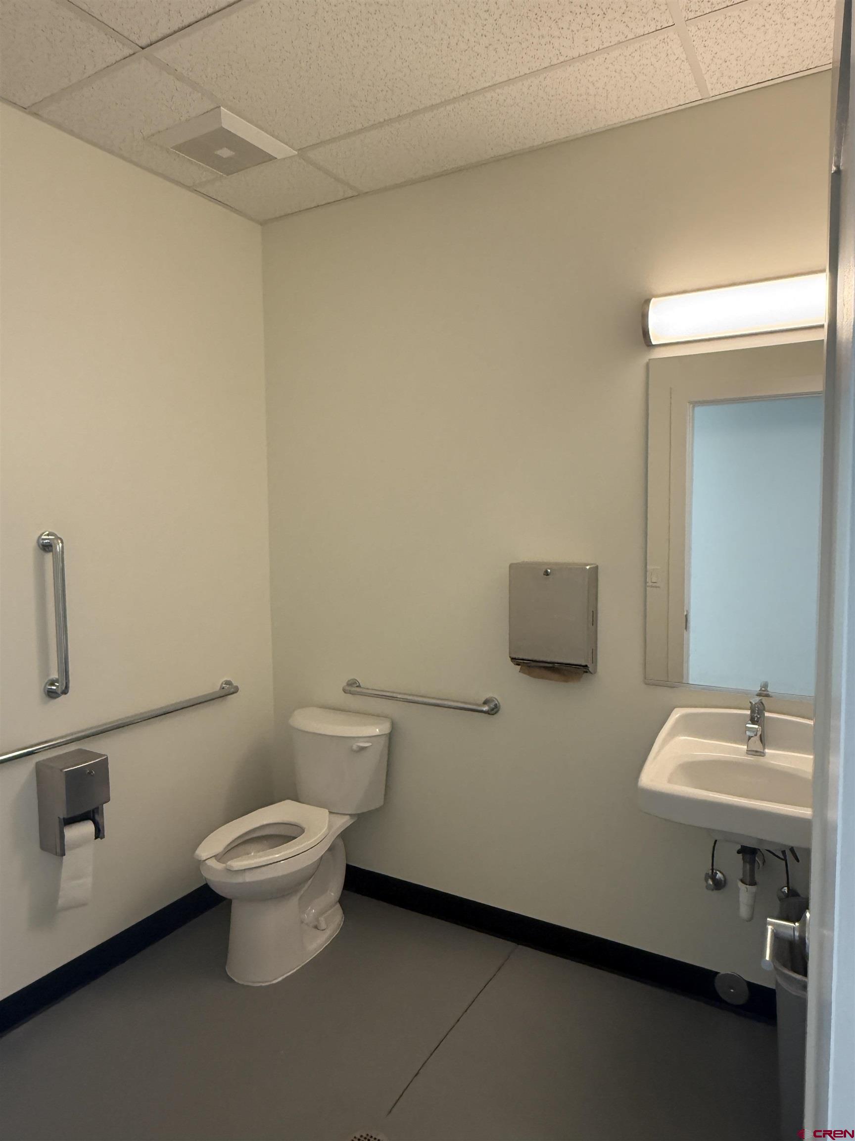 205 Jasper Lane, Unit 101 Ridgway, CO 81432 - Photo 19 of 28 a bathroom with a sink a toilet and a mirror