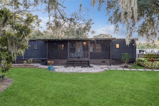 a view of a house with a yard and sitting area